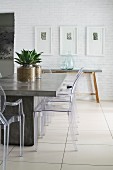 Concrete table and plexiglas chairs in modern dining room
