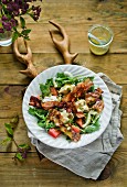 An autumnal rocket salad with bacon and brie