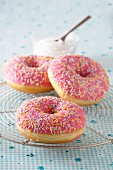 Pink glazed doughnuts with sugar sprinkles