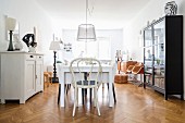 Dining table and vintage furniture on herringbone parquet flooring