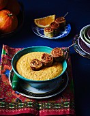 Orange and carrot soup with pancake rolls