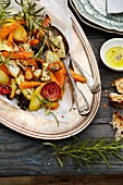 Oven-roasted vegetables with rosemary on a silver platter