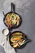 Roasted baby carrots and fennel bulbs with avocado, seeds and tahini yoghurt