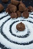Chocolate truffles on a swirl of grated coconut
