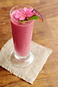 A plum smoothie with raspberries, strawberries, banana and almond yoghurt