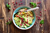 Veganer Bulgur-Salat mit Gemüse, Avocado und Granatapfelkernen (Aufsicht)