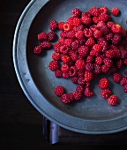 Wild raspberries on a metal plate