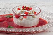 Greek yoghurt with pistachio nuts and strawberry sauce