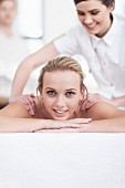 A woman receiving a massage at a spa