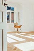 Pram in empty room with open door