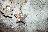 Christmas arrangement of wooden star and Christmas tree on artificial snow on wooden surface