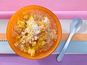 Millet and coconut muesli with fresh pineapple (seen from above)