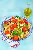 Pasta with steamed tomatoes, feta cheese, olives and rocket