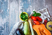 An arrangement of fresh vegetables, herbs and couscous (seen from above)