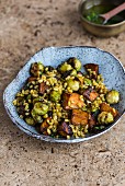 A winter green salad with roasted unripe spelt grains and vegetables