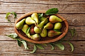 Wild pears in an oval wooden bowl