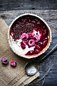 Semolina pudding with warm and frozen raspberries and grated chocolate