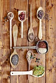 Dried superfoods on wooden spoons (seen from above)