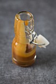 Caramel sauce in a small flip-top bottle