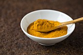 Ground turmeric in a small bowl