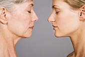 An older and young woman standing opposite each other