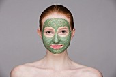 A young woman with a green face mask
