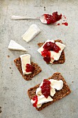 Slices of wholemeal bread topped with Camembert and cranberry jam