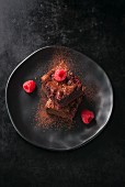 Chocolate brownies with cocoa powder and fresh raspberries