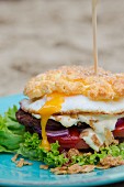 Cloud bread burger with a runny fried egg and roasted onions