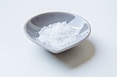 Fleur de Sel in a dish on a white surface