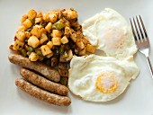 Fried eggs with sausages and fried potatoes