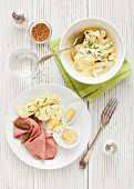 Potato salad with pastrami, hard-boiled eggs and gherkins