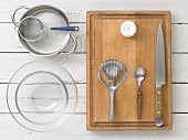 Kitchen utensils: glass bowls, a saucepan, a sieve, an egg piercer and an egg slicer