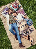 A hippie-style couple lying in a meadow