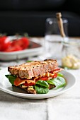 A BLT Sandwich with bacon, tomato and spinach