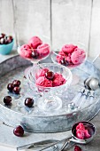 Cherry sorbet with fresh cherries in glass serving dishes