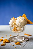 Vanilla ice cream with honeycomb in a glass serving dish