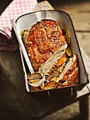 Crispy shoulder of suckling pig on a bed of oven-roasted vegetables