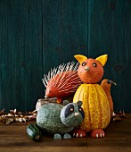 Pumpkin decorations for Halloween: a fox, raccoon and hedgehog
