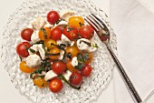 Grape tomato salad with mozzarella and basil (seen from above)