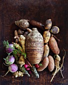 Assorted root vegetables on a wooden surface