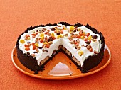A Halloween cake filled with chocolate bars and decorated with chocolate coated peanuts