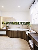An organically designed bathroom with shelves and a floral photo panel