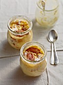 Bavarian Topfenstrudel (strudel with a soft quark cheese) with caramelised plums served in glass jars