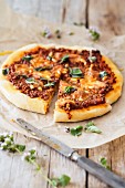 Minced meat pizza, sliced