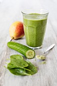 A green smoothie with cucumber, spinach, pear and wheatgrass