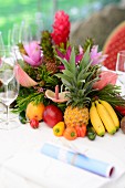 Exotische Früchtedeko mit Blumen als Tischdeko zum karibischen Buffet