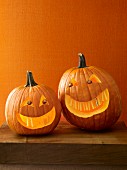 Two Halloween pumpkins with scary faces