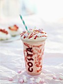 A creamy summer drink with strawberry sauce and marshmallows