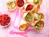 Wafer cones with red berry jelly and green fruit jelly